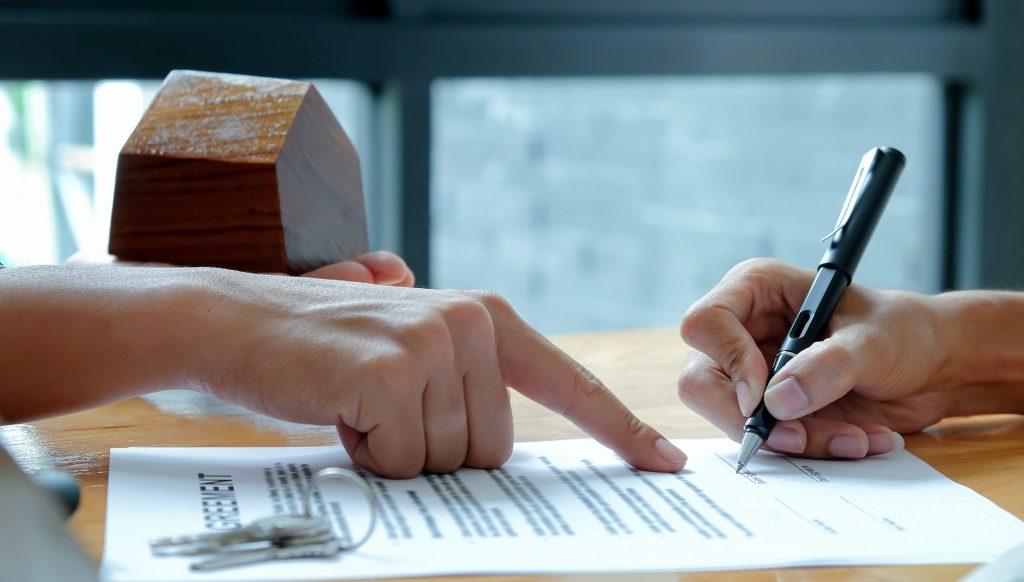 The house broker pointed to the hand documents that customers signed a contract to buy a home loan.